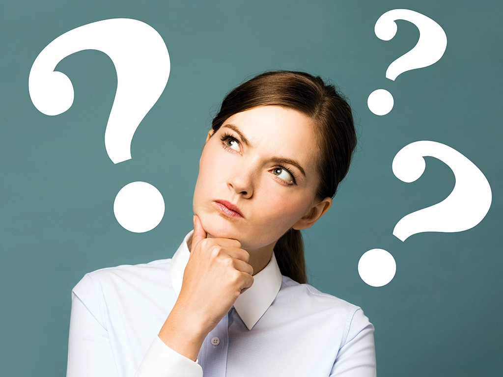 young woman thinking with graphic question marks around her