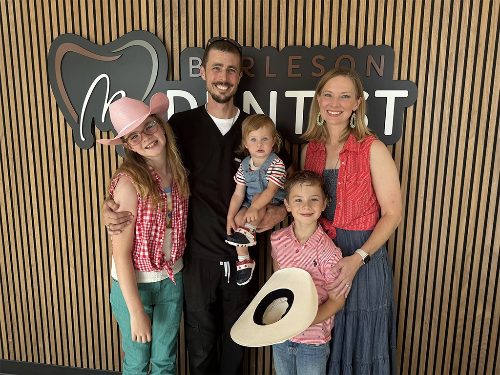 doctor robert davis and family in front of office sign
